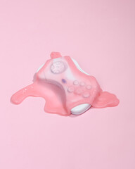 Creative 80s layout, retro gamepad with slime on pink background with shadow. Visual trend. Fresh idea. Concept pop © splitov27