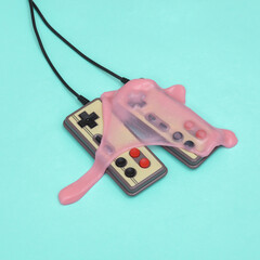 Creative retro layout, old gamepads with slime on blue pastel background. Visual trend. Fresh idea....