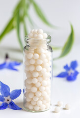 Homeopathy - vertical close-up vial filled with granules