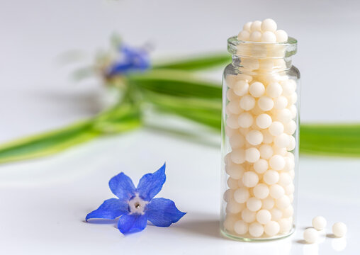 Homeopathy-Small glass bottle filled with granules.