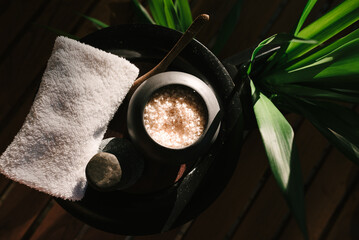 Balinese spa setting, frangipani with sea salt and coconut. Hot Stone Massage Set.
