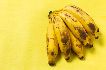 Ripe fruit banana apple organic well in isolated yellow background ripe and tasty in the background