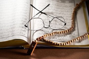 Reading glasses holy book koran and prayer beads