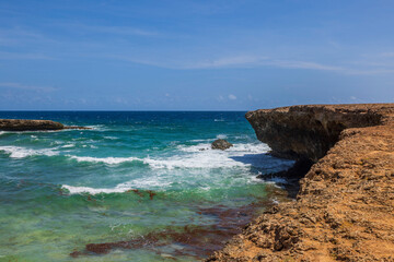 Beautiful view of big turquoise waves on western rocky coast of island of Aruba.