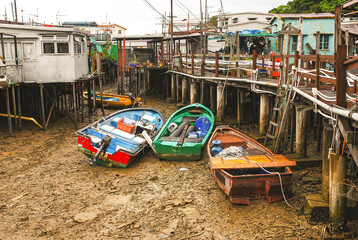 Fototapeta na wymiar Tai O fishing village, Lantau Island. Primitive sheet metal houses stand on stilts to which fishing boats are moored. A popular tourist attraction in Hong Kong.
