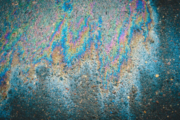 Puddles are contaminated with multicolored streams of oil.