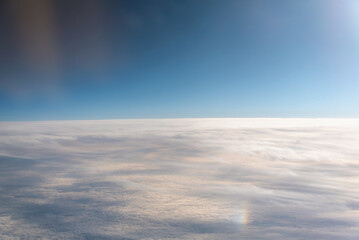 view from the airplane window landscape above the clouds