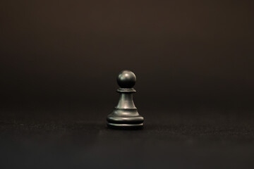 chess pawn piece on black background