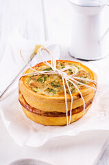 Traditional French tart cake with tuna fish and cheese cream served as close-up on a wooden board