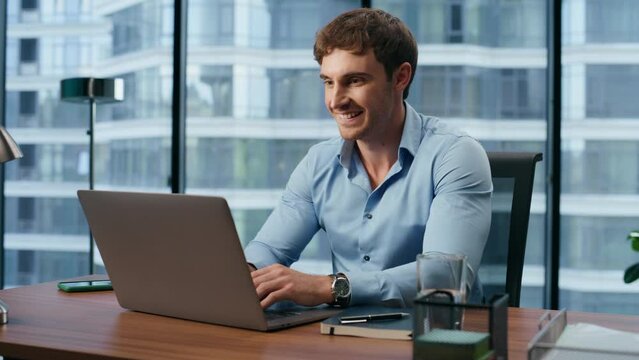 Happy boss working laptop in city view office. Manager chatting social media