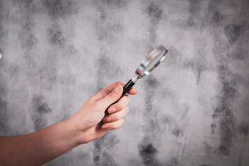 young woman holding a magnifying glass