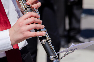 Fototapeta premium close-up view of a girl's hands playing the clarinet, music learning