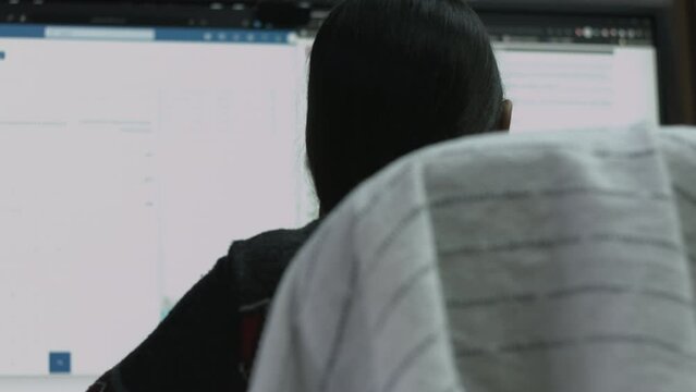 Young Female Office Employee Performs Tasks at Her Desk 4K