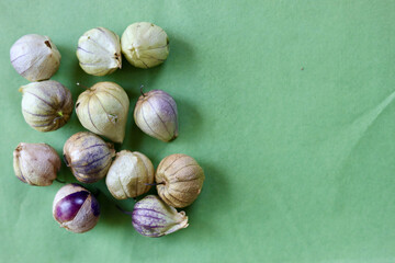 Purple tomatillos on green background