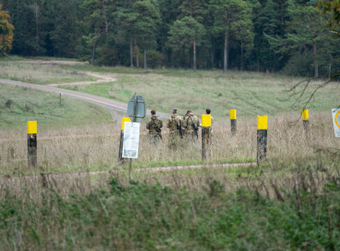 a group of army soldier marksmen prepare for a military exercise