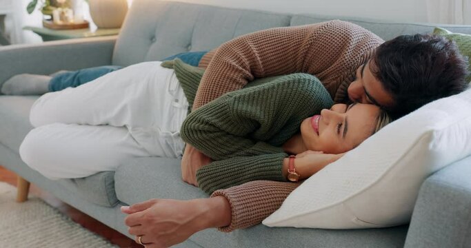 Kiss, smile and couple sleeping on the sofa in the living room of their house together. Relax, happy and calm man and woman tired and cuddling on the couch in their home with affection and love