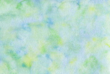 Abstract watercolor background. Delicate shades of green and blue on watercolor paper. Picturesque spots of paint.