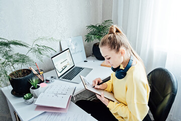 How to Make Create Resume. Young woman student writing resume or cv letter for applying for a job...
