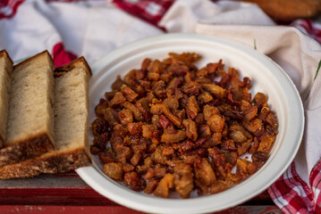 fried goose cracklings on a white plate table.