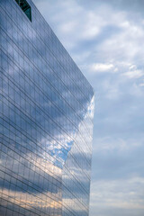 Fototapeta na wymiar Glass building with cloudy sky reflected on the windows in Austin Texas