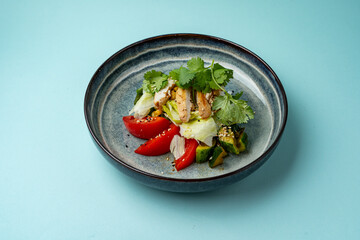 salad with chicken on a plate on a colored background