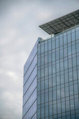 Fototapeta na wymiar A modern building with glass facade against cloudy sky in Austin Texas