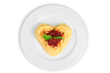 Cooked spaghetti carefully arranged in a heart shape and topped with tomato sauce accompanied by raw ingredients to the side