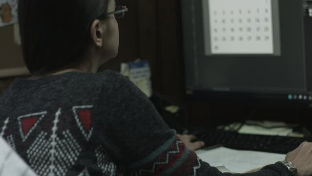 Young Female Office Employee Performs Tasks at Her Desk 4K