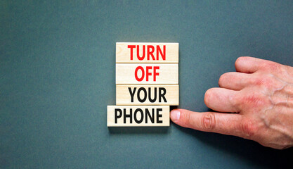 Turn off your phone symbol. Concept words Turn off your phone on wooden blocks. Beautiful grey...