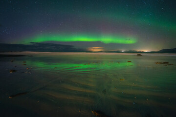 Naklejka na ściany i meble Beautiful colorful northern lights captured in the Lofoten Islands in northern Norway.