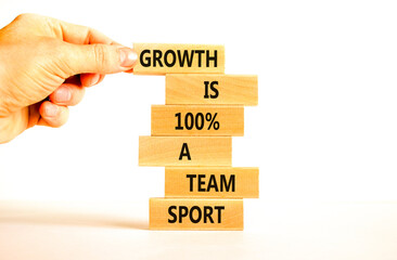 Growth symbol. Concept words Growth is 100 percent a team sport on wooden blocks on a beautiful white table white background. Businessman hand. Business motivational and growth is a team sport concept