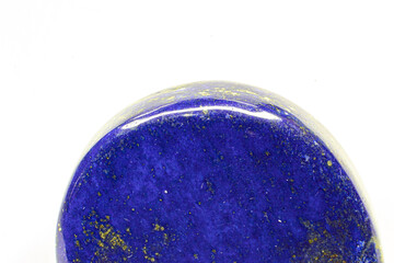 Polished deep blue Lapis lazuli rock macro isolated against white background
Dark blue Lapis lazuli...