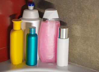 Containers and bottles of different sizes, shapes and colors for cleanser, conditioner, soap and shampoo in the bath. Natural organic cosmetics, packaging with an empty label, branding layout.