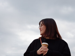 Beautiful Japanese woman drinking a hot coffee outside - 540135341