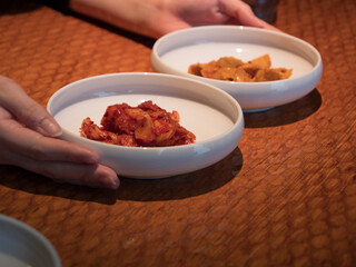 Hands picking at side dishes in a Korean restaurant - 540135929