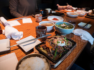 A Korean main course with beef and egg topping rice - 540135970