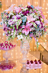 a table decorated with sweets in bowls and flower pots
