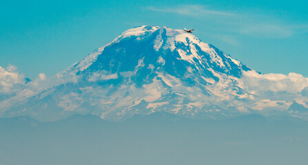 Airplane passing by Mount Rainier from Seattle