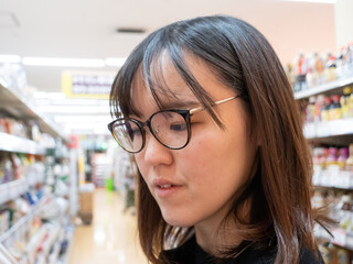 A young Japanese woman grocery shopping - 540137704
