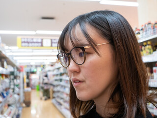 A young Japanese woman grocery shopping - 540137757