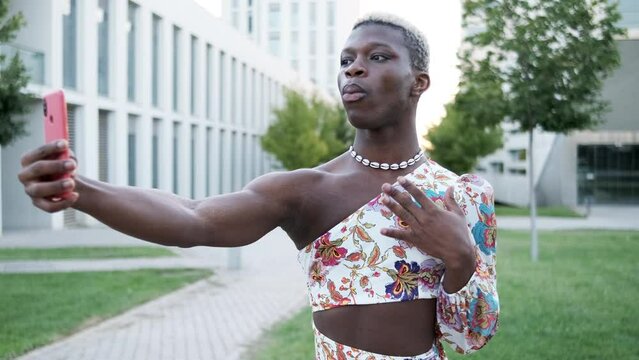 Black non binary person taking selfie in park