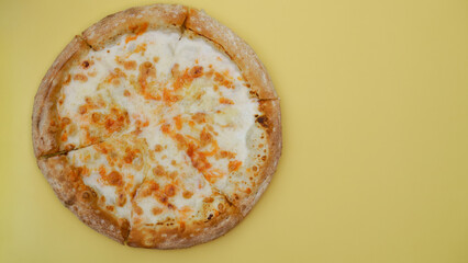 cheese pizza lies on a plain background close-up. minimalist food concept, color combination, copy space, top view