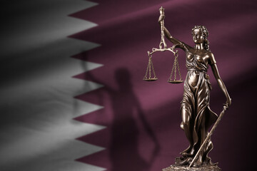 Qatar flag with statue of lady justice and judicial scales in dark room. Concept of judgement and punishment