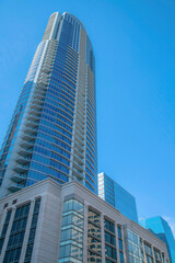 Fototapeta na wymiar Towering modern building with blue sky background in sunny Austin Texas