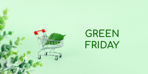 Organic tree leaf in a supermarket shopping cart surrounded by foliage. Green friday is the new...