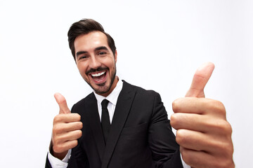 Fototapeta na wymiar Portrait of a man in an expensive business suit close-up wide-angle lens pulls his hands into the camera with open mouth surprise happiness and shows thumbs up on white background, copy space
