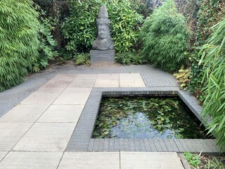 Meditation garden terrace with pond. Statue of Buddha creates the right mood for meditation. Appeltern, Netherlands, October 12, 2022: Appeltern is the Netherlands' largest garden idea park 