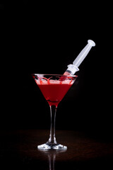 halloween party with drink in martini glass and blood syringe in glass