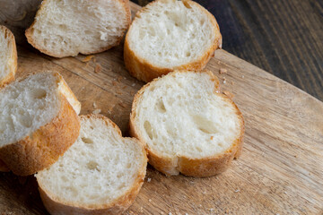 Sliced wheat baguette on a board