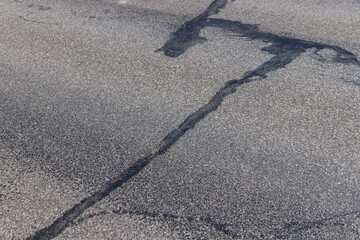 Fototapeta na wymiar Repaired asphalt road in close-up